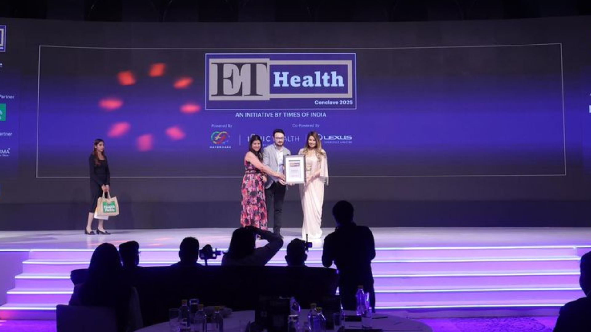 Dr. Sushil Kotru receiving award from Mahima Chaudhary